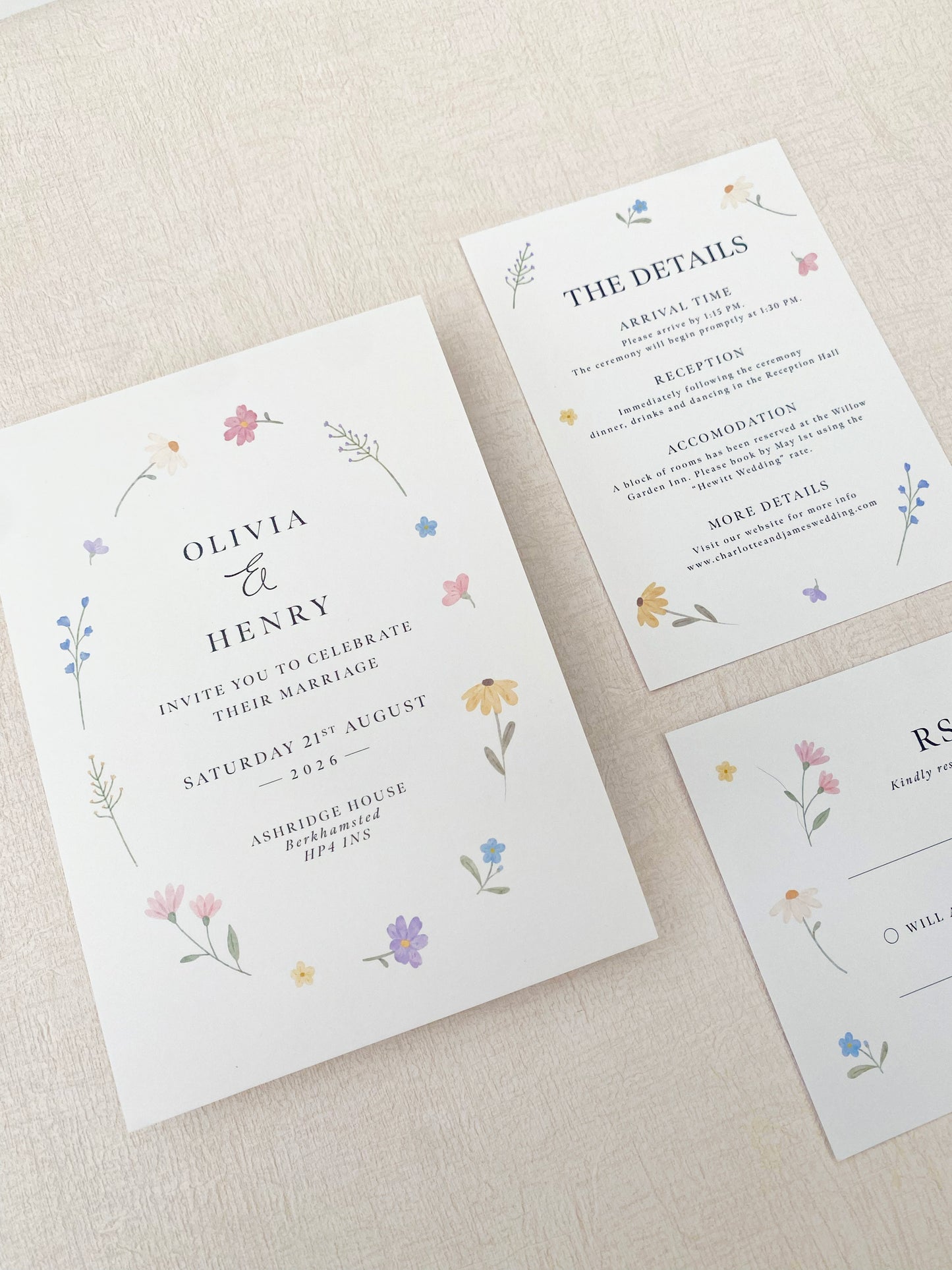 Hand painted wildflower wedding invitation with soft pastel florals for a spring wedding