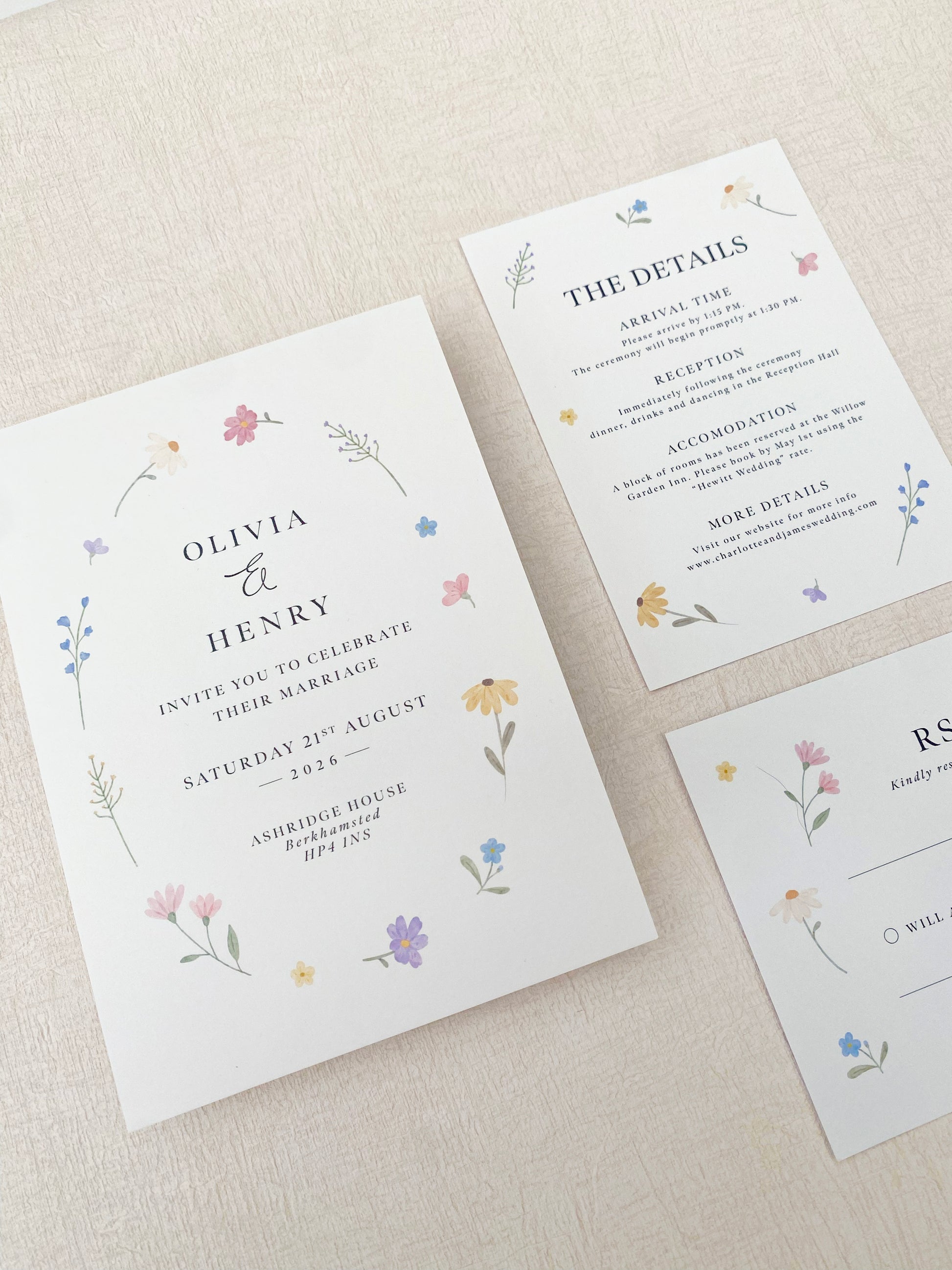 Hand painted wildflower wedding invitation with soft pastel florals for a spring wedding