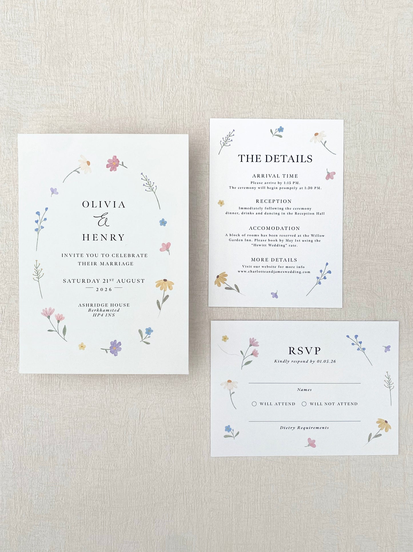Set of wedding invitations with wild flower floral designs on a textured beige background