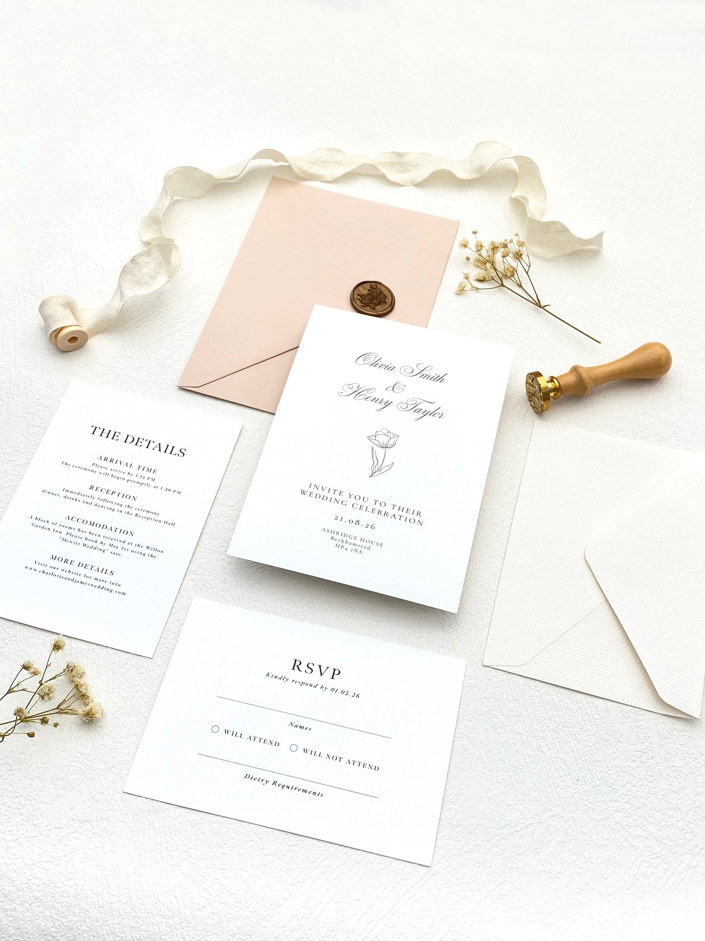 Flat lay of a luxury custom wedding invitation suite in muted tones featuring elegant typography and coordinated stationery.