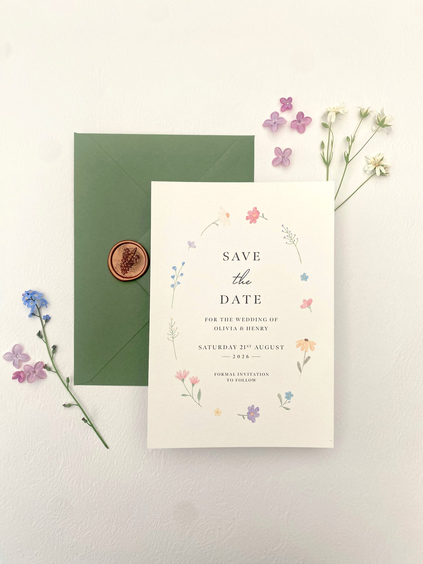 Spring wedding save the date featuring delicate wildflowers, elegant floral announcement card with wax seal envelope